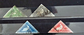 Four triangular stamps from Cape of Good Hope on a black background