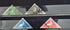 Four triangular stamps from Cape of Good Hope on a black background