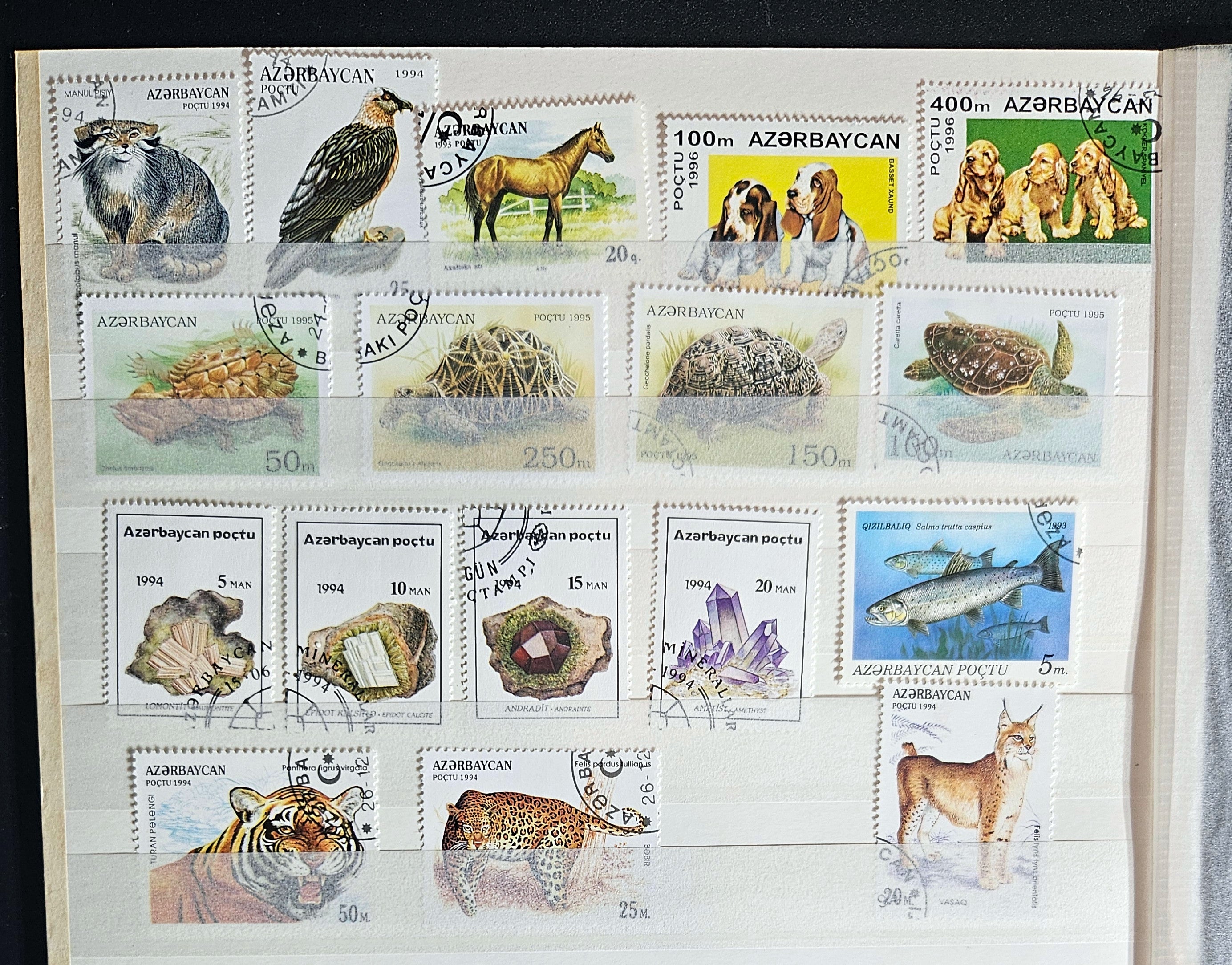 A collection of Azerbaijan stamps showcasing various birds, animals, and natural landmarks.