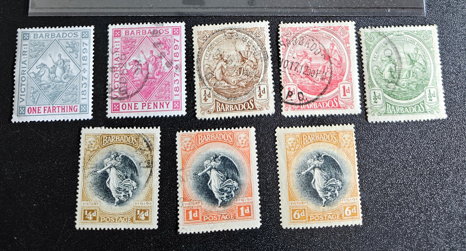 A set of vintage postage stamps from the British Commonwealth, featuring various designs and denominations, arranged in a row.
