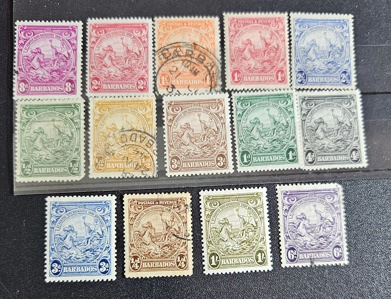 A set of vintage postage stamps from the British Commonwealth, featuring various designs and denominations, arranged in a row.