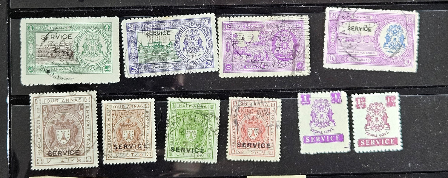 A collection of vintage Indian stamps from various feudatory states including Jhind, Bhopal, Saurashtra, Hyderabad, and Holkar, displayed on a flat surface.