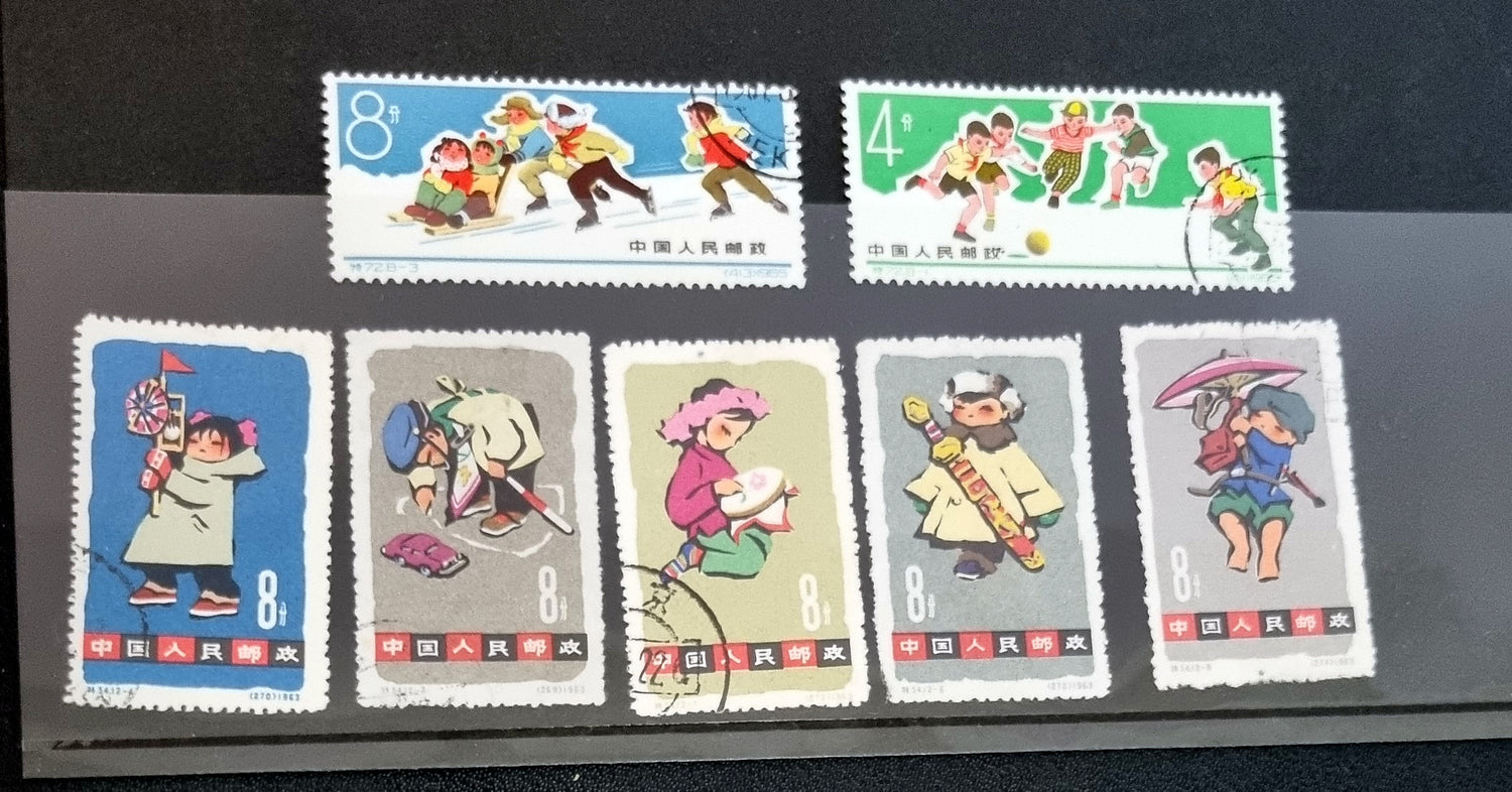 A collection of various Chinese stamps arranged in rows, showcasing different designs and colors.