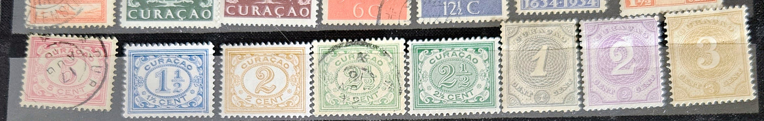 A collection of vintage postage stamps from the Netherlands colonies, featuring various designs and denominations.