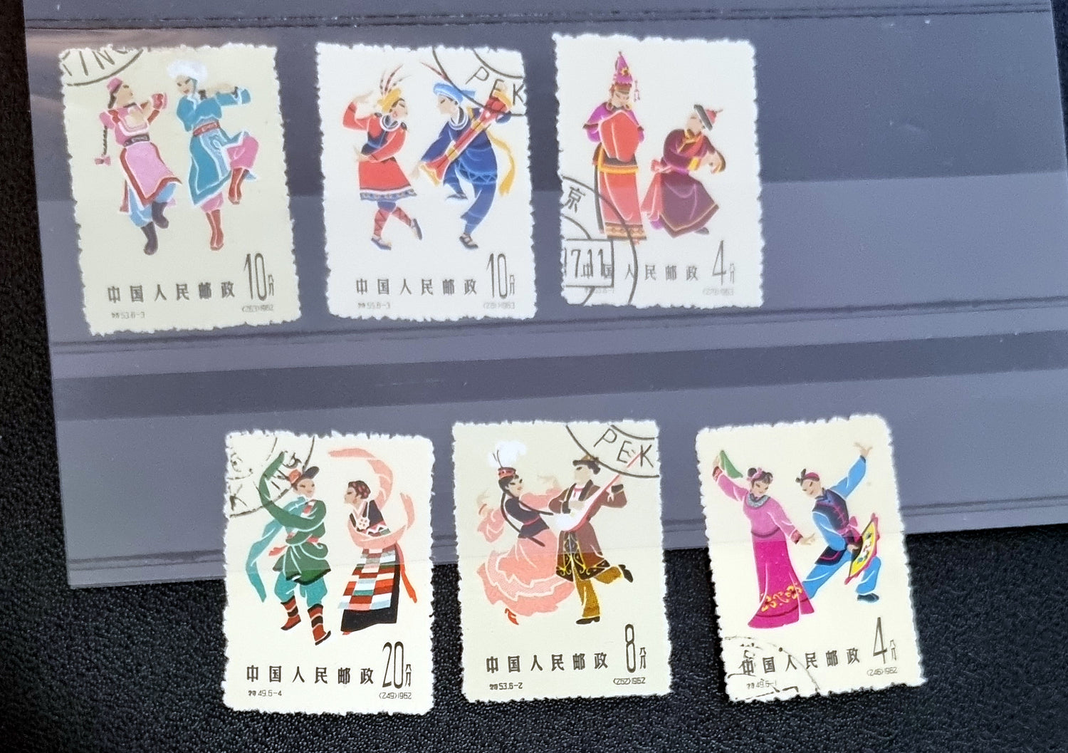 A collection of various Chinese stamps arranged in rows, showcasing different designs and colors.
