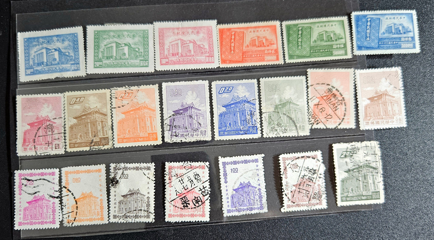 A collection of various Chinese stamps arranged in rows, showcasing different designs and colors.