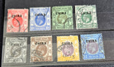 A collection of vintage Hong Kong stamps from various queens to post-handover issues, displayed on a surface.