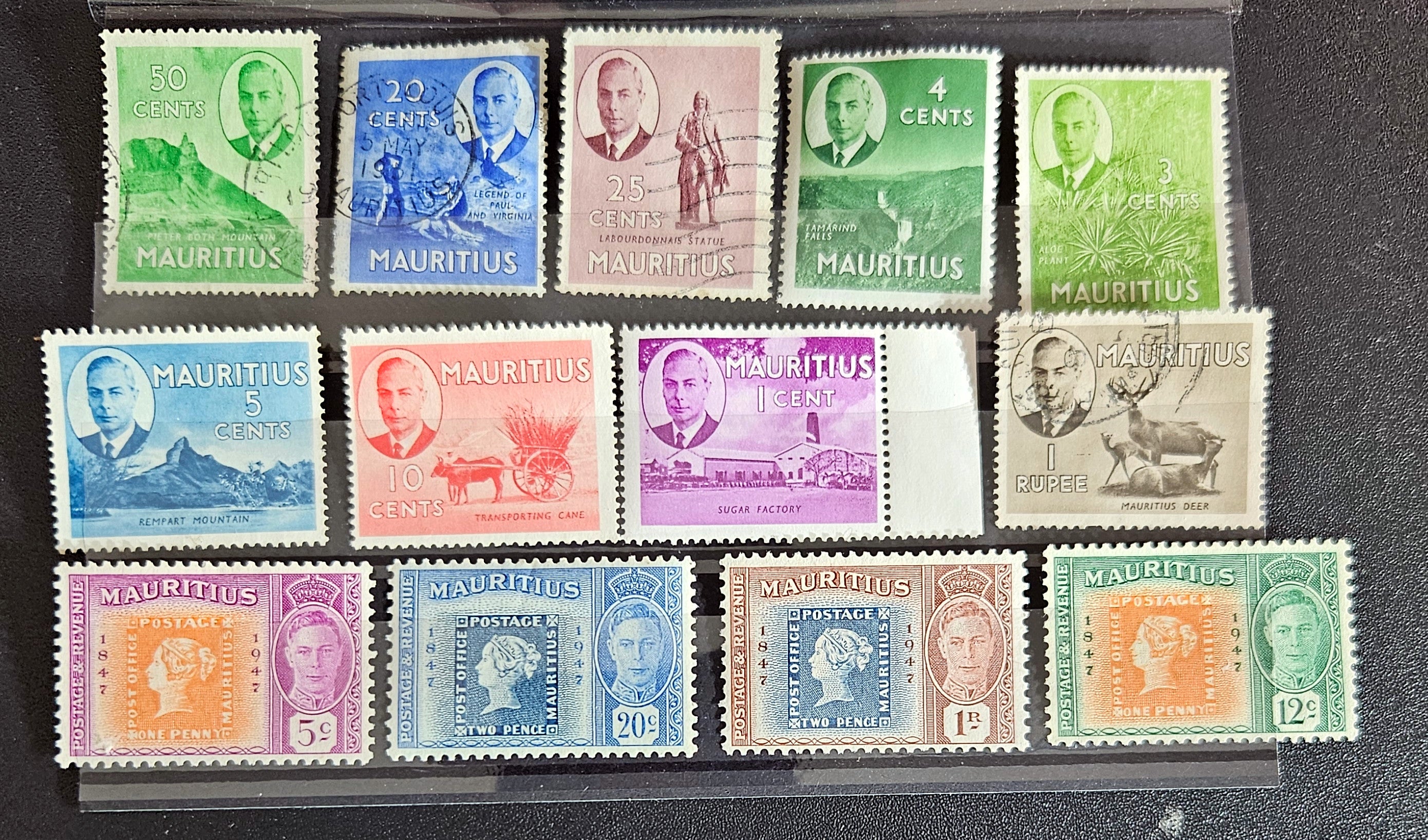 A collection of vintage postage stamps from Mauritius displayed in a row, featuring various designs and denominations.