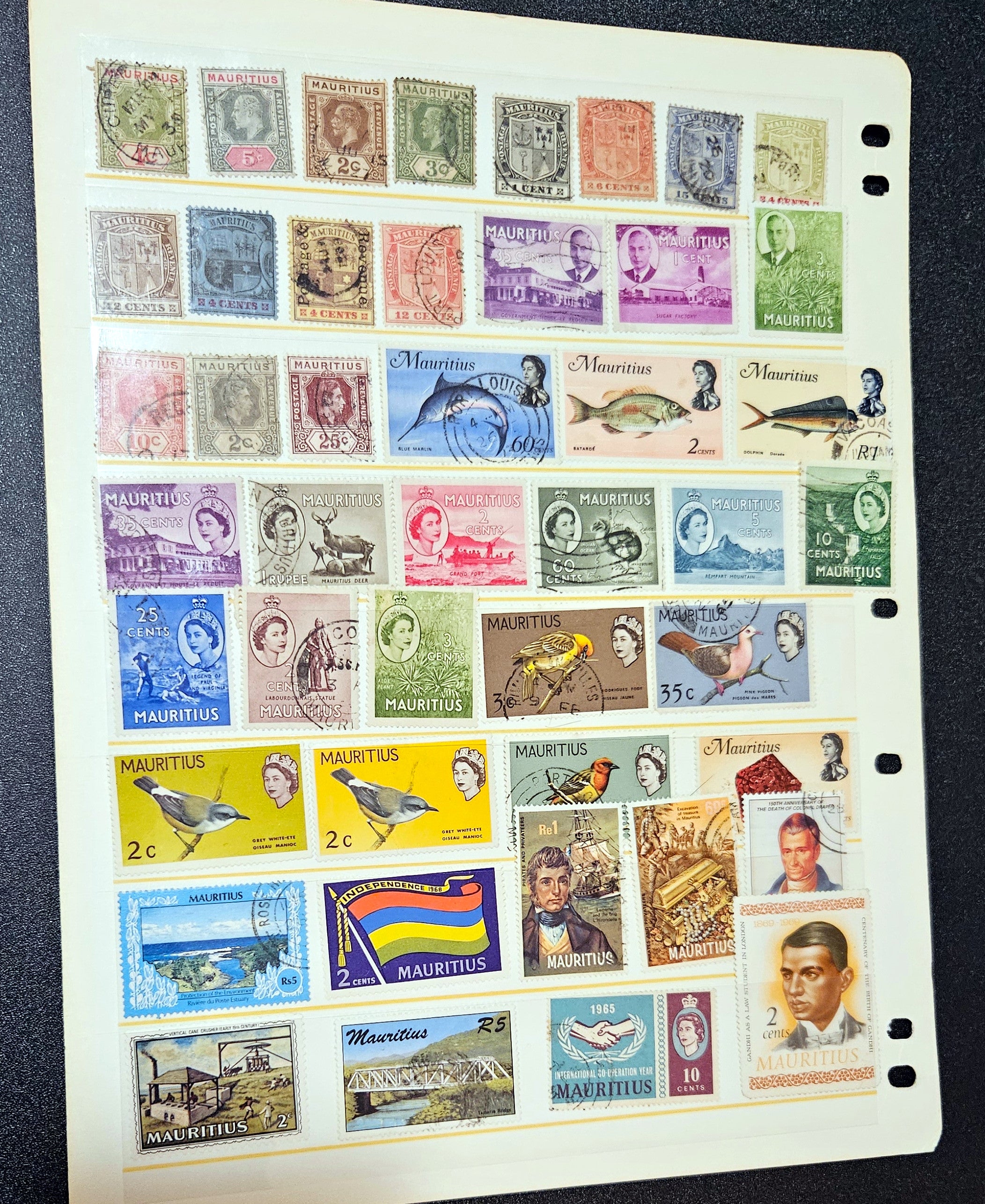 A collection of vintage postage stamps from Mauritius displayed in a row, featuring various designs and denominations.