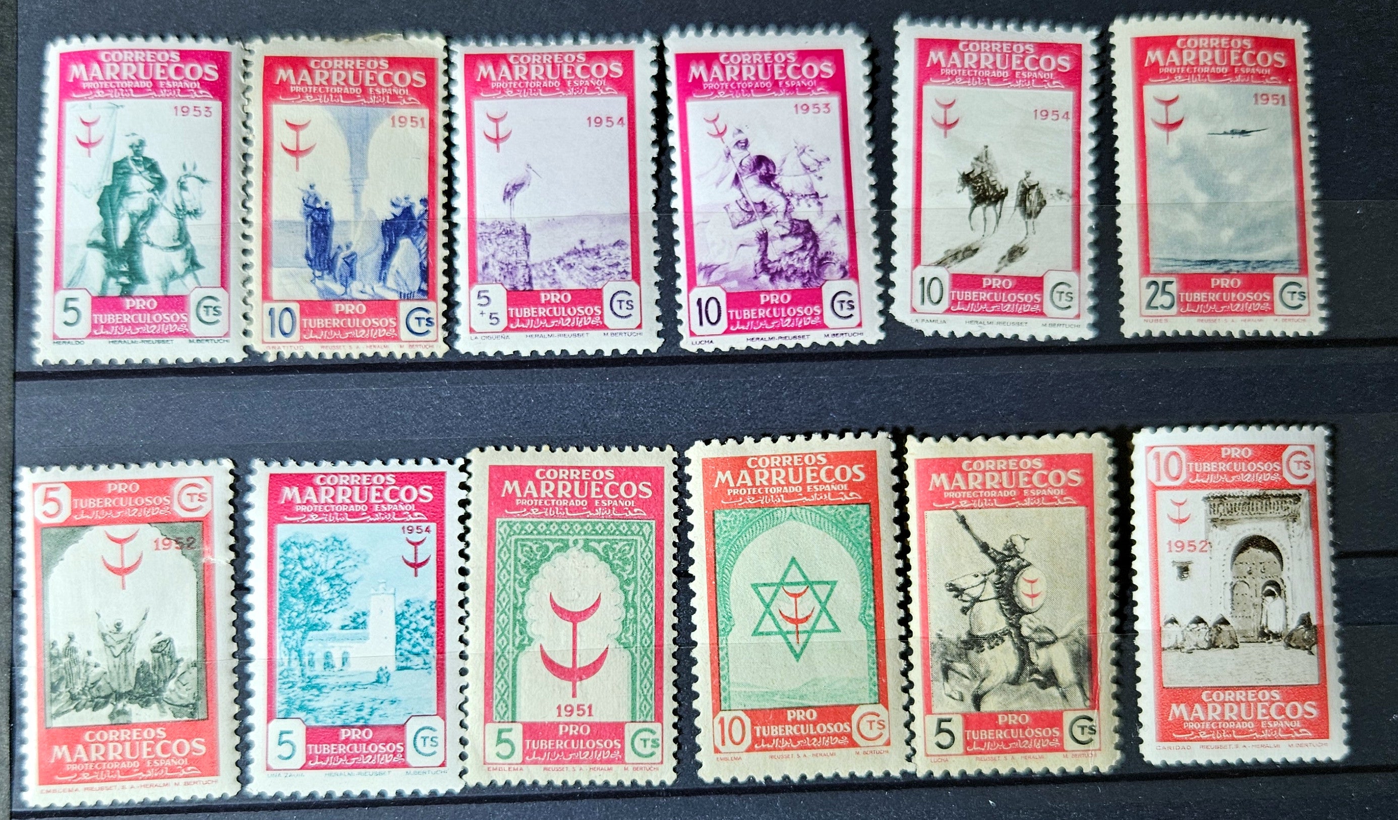 Collection of vintage stamps with different designs and colors on a dark background.