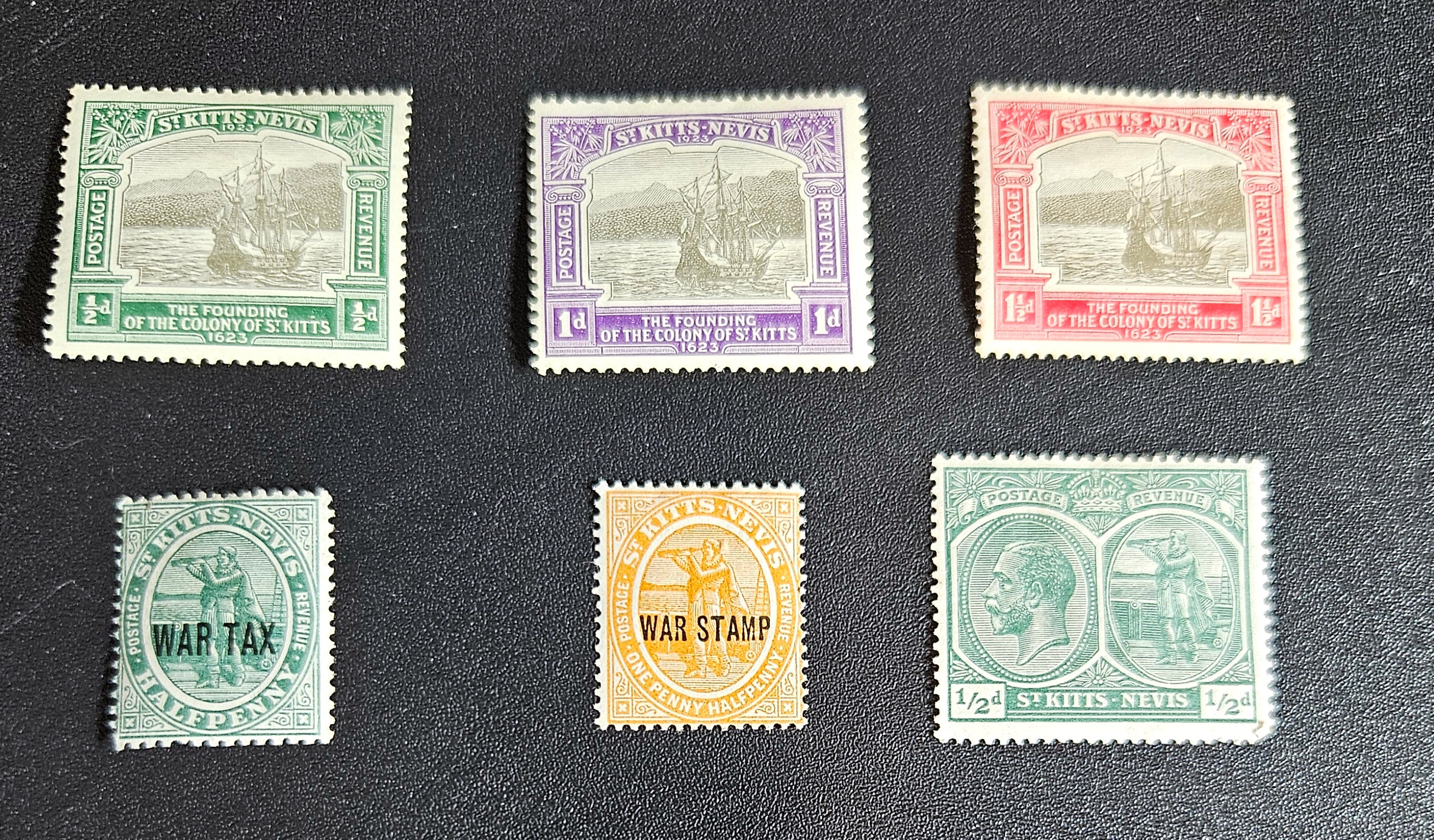 A collection of vintage St Kitts and Nevis stamps displayed against a dark background. The stamps vary in color and design, featuring various denominations and historical figures.