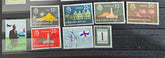 A collection of vintage postage stamps from the Netherlands colonies, featuring various designs and denominations.
