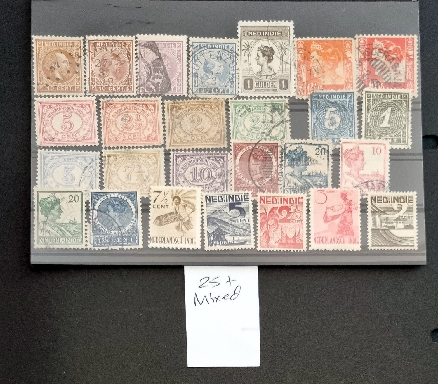 A collection of vintage postage stamps from the Netherlands colonies, featuring various designs and denominations.