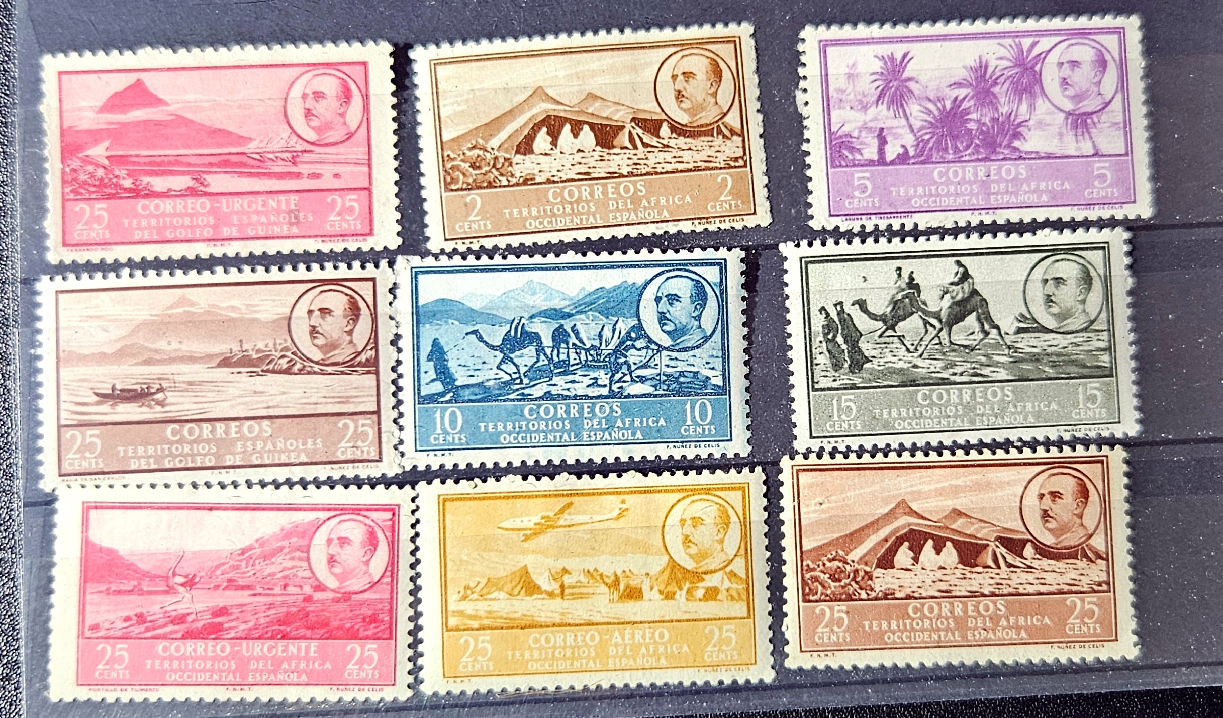 Collection of vintage stamps with various designs and colors on a dark background