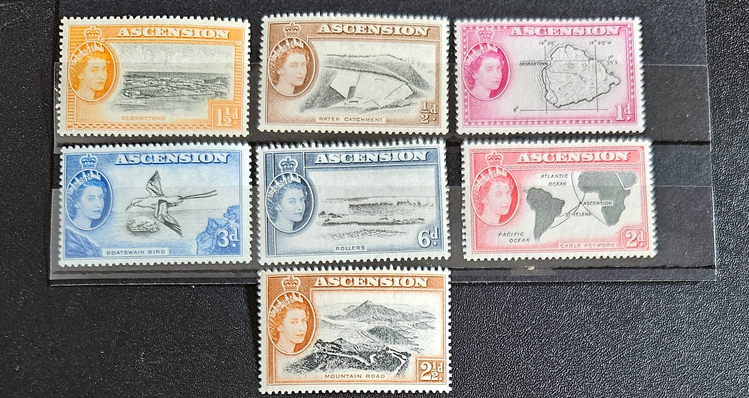 A collection of British Commonwealth Ascension vintage stamps displayed on a surface, featuring various colors and images representing different historical periods.
