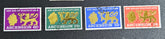 A collection of British Commonwealth Ascension vintage stamps displayed on a surface, featuring various colors and images representing different historical periods.