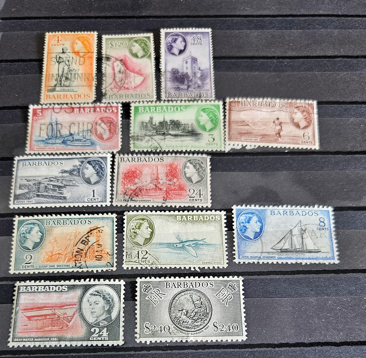 A set of vintage postage stamps from the British Commonwealth, featuring various designs and denominations, arranged in a row.