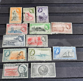 A set of vintage postage stamps from the British Commonwealth, featuring various designs and denominations, arranged in a row.