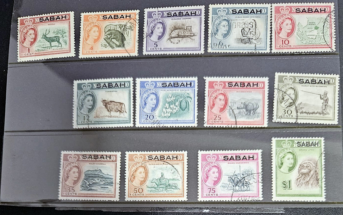 Collection of vintage stamps from Sabah with different designs and values.