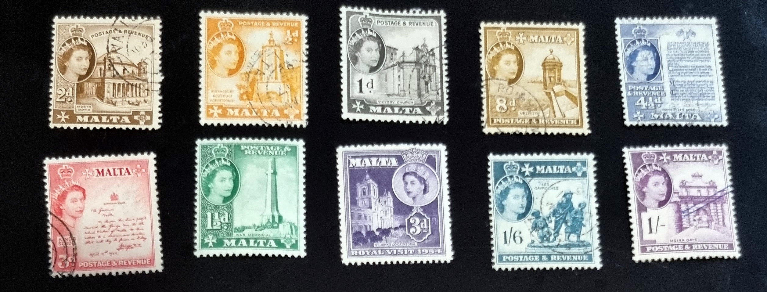 A collection of vintage postage stamps from Malta featuring various designs and colors, arranged in no specific order on a surface.