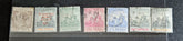 A set of vintage postage stamps from the British Commonwealth, featuring various designs and denominations, arranged in a row.