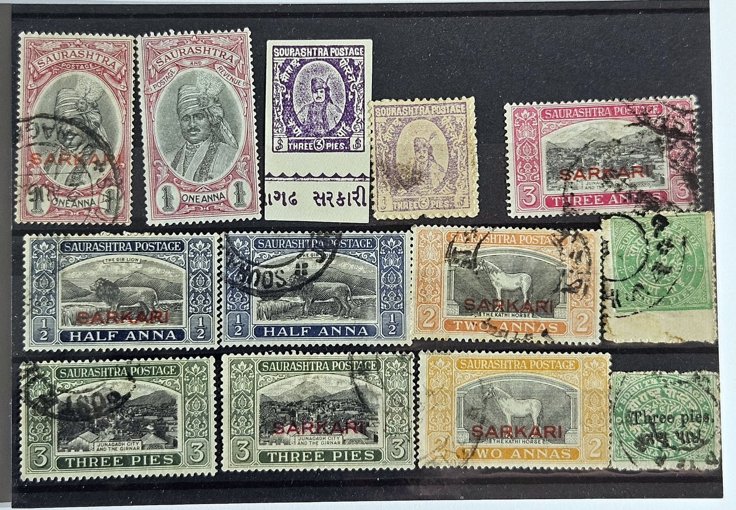 A collection of vintage Indian stamps from various feudatory states including Jhind, Bhopal, Saurashtra, Hyderabad, and Holkar, displayed on a flat surface.