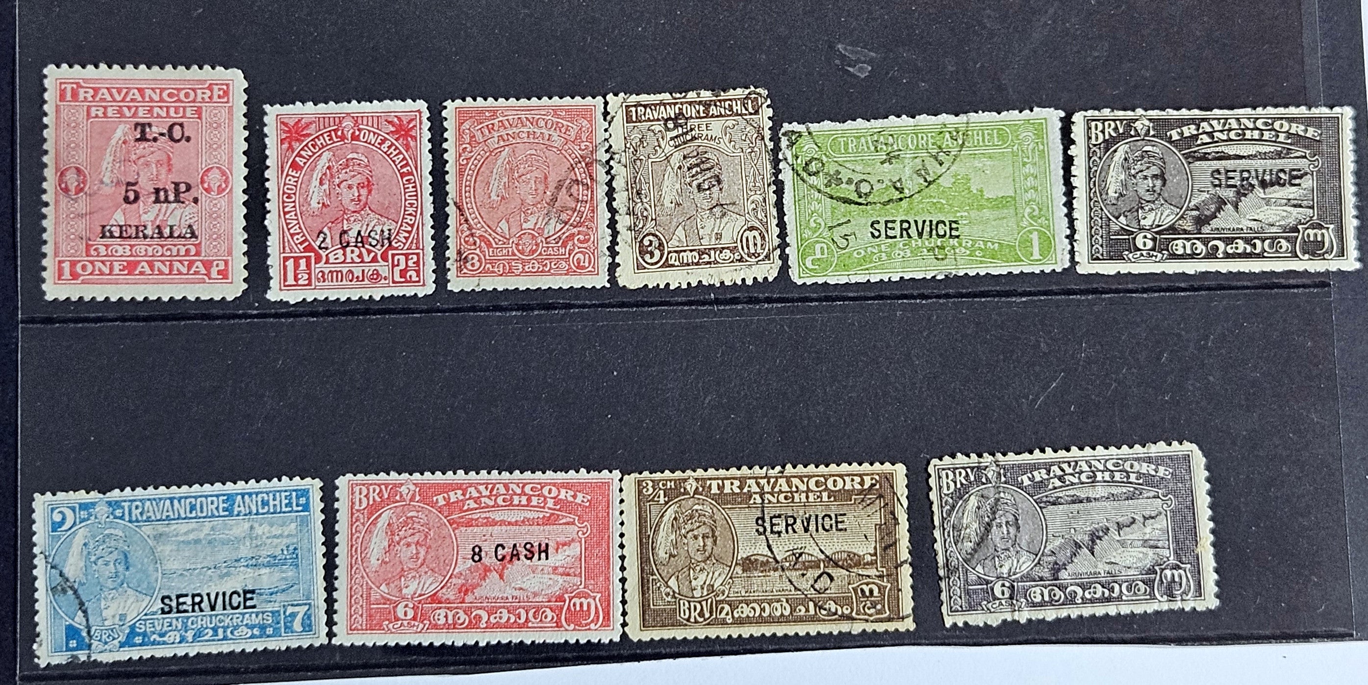 A collection of various Indian postage stamps displayed in a row, showcasing different colors and designs.