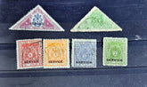 A collection of vintage Indian stamps from various feudatory states including Jhind, Bhopal, Saurashtra, Hyderabad, and Holkar, displayed on a flat surface.