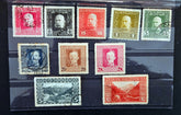 Collection of vintage stamps with different designs and colors on a black background