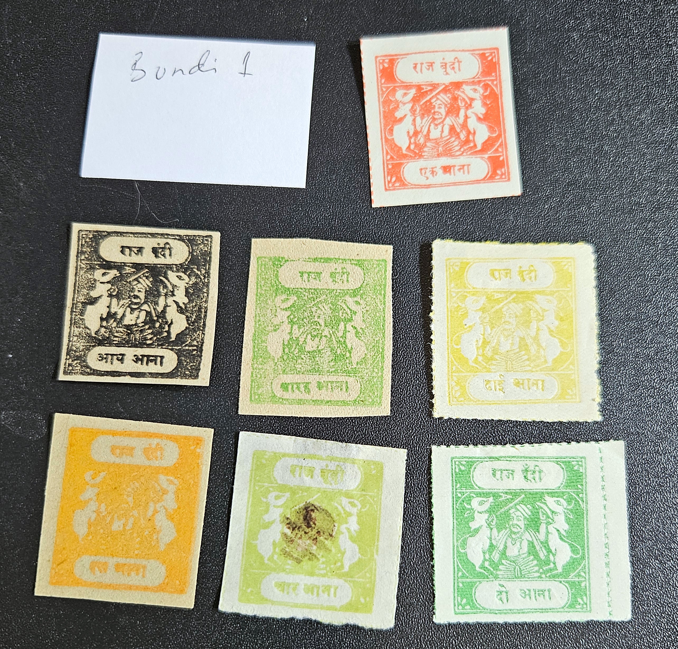 A collection of vintage postage stamps from various Feudatory States of India, featuring different colors and designs, placed on a flat surface.