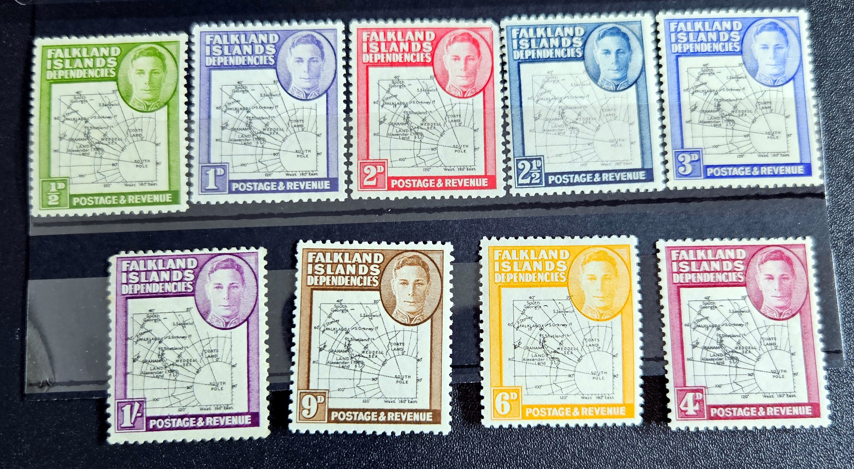 A set of vintage Falkland Islands stamps from various reigns, displayed in a row.