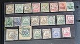 A collection of vintage postage stamps from various German colonies, featuring different colors and designs, arranged in a row on a white background.