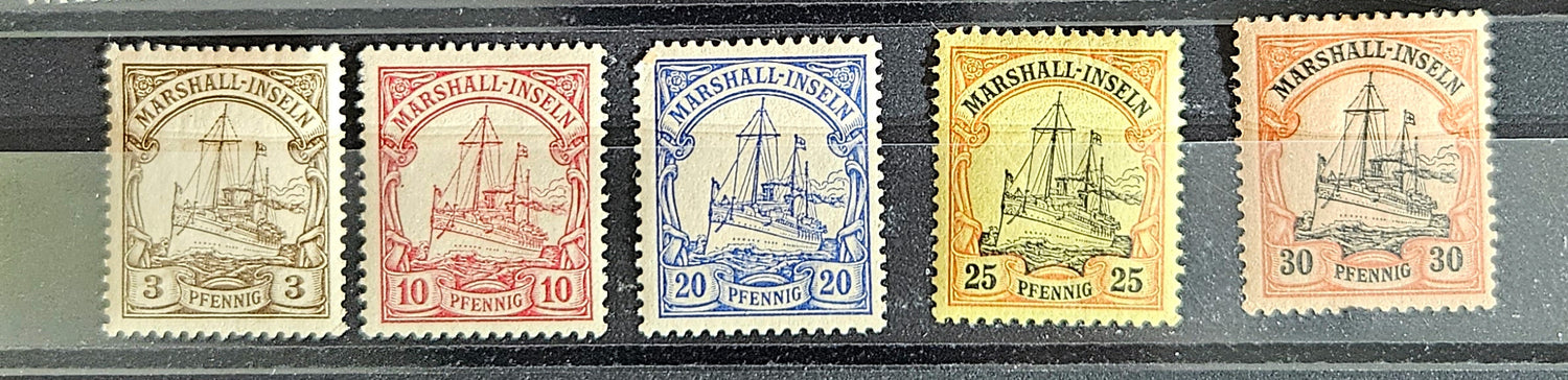 A collection of vintage postage stamps from various German colonies, featuring different colors and designs, arranged in a row on a white background.