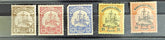 A collection of vintage postage stamps from various German colonies, featuring different colors and designs, arranged in a row on a white background.