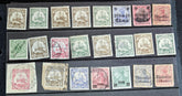 A collection of vintage postage stamps from various German colonies, featuring different colors and designs, arranged in a row on a white background.