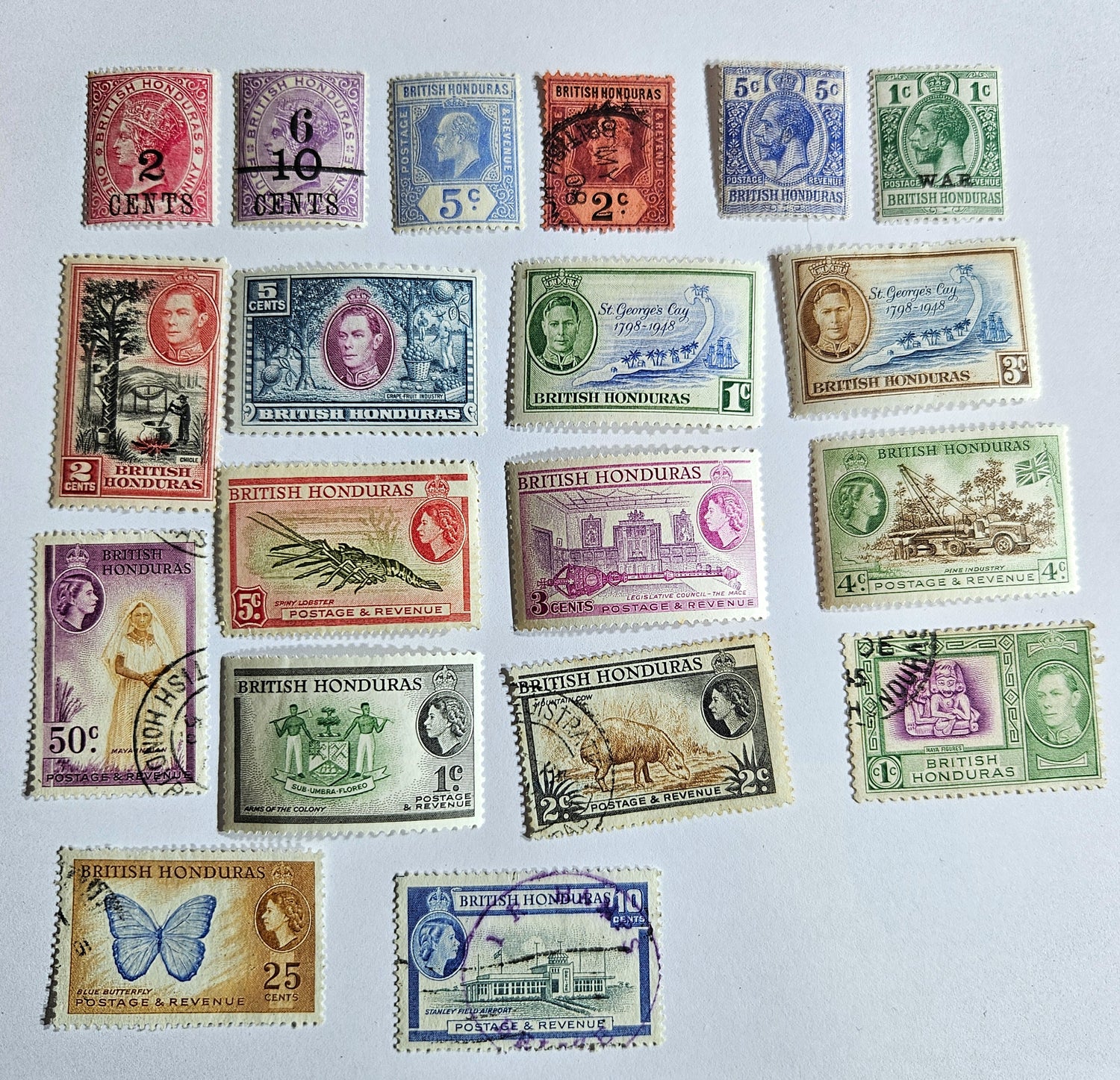 A collection of vintage Commonwealth British Honduras stamps from various reigns, displayed on a white background.