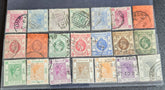 A collection of vintage Hong Kong stamps from various queens to post-handover issues, displayed on a surface.