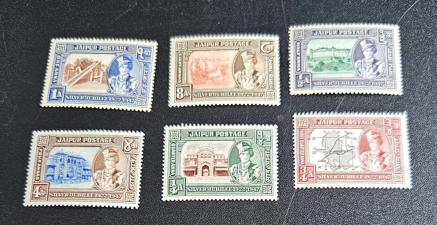 A collection of vintage stamps from Jaipur, India, featuring various designs and denominations, with visible signs of wear.