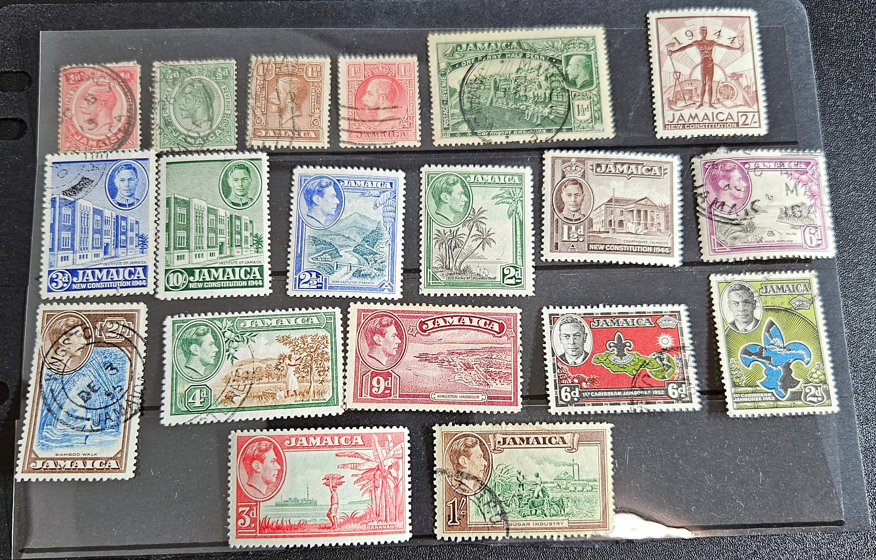A collection of vintage Jamaica stamps from various reigns of British monarchs, displayed on a black background.