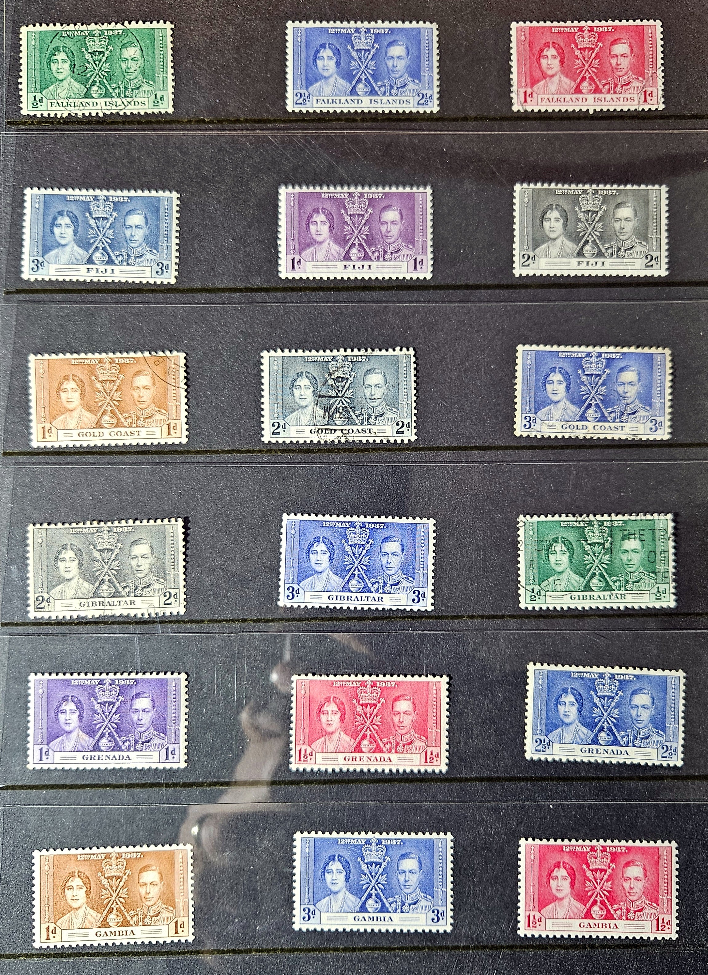 Collection of vintage stamps with royal portraits on a black background