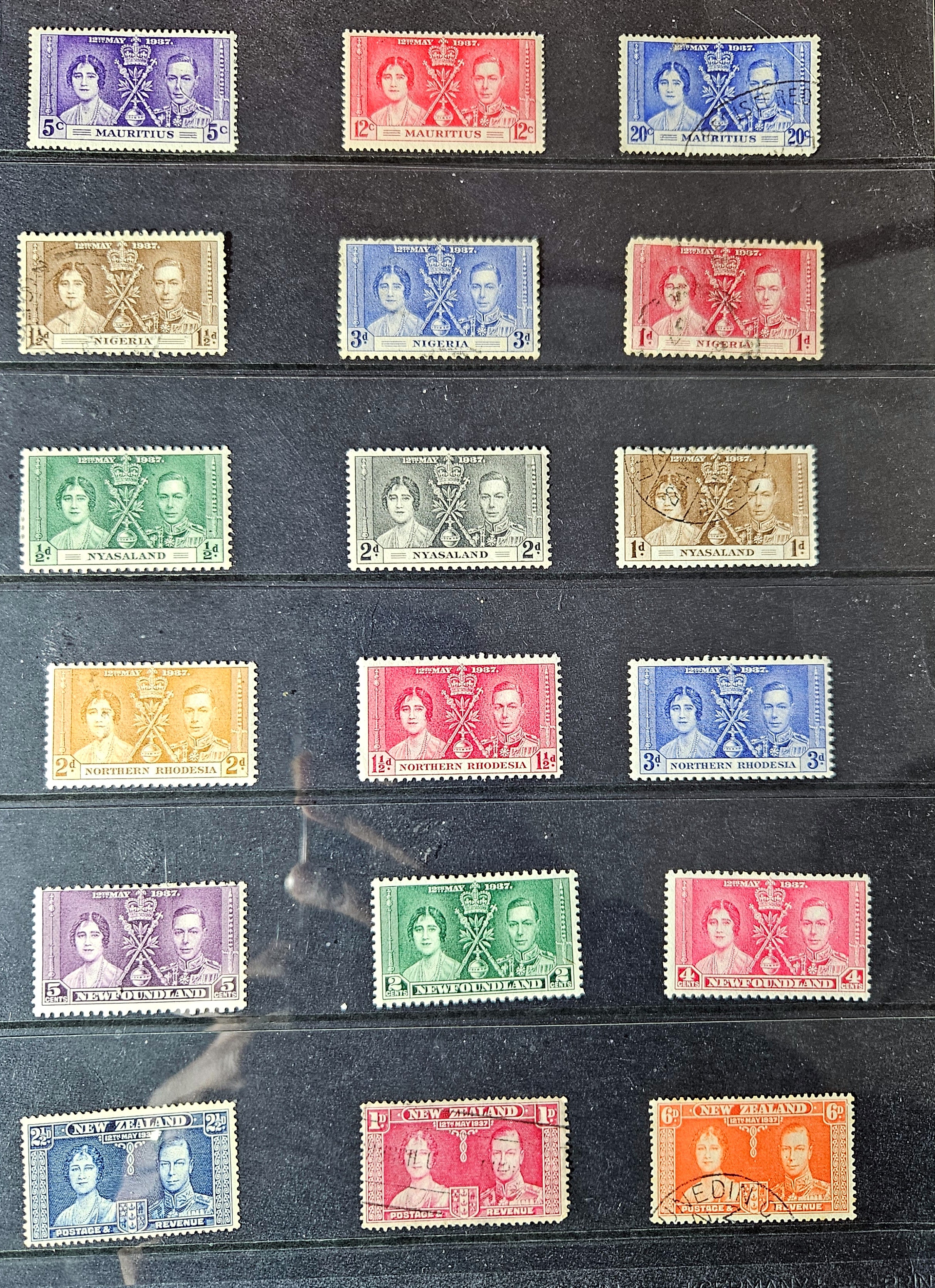 Collection of vintage stamps with various colors and designs on a dark background