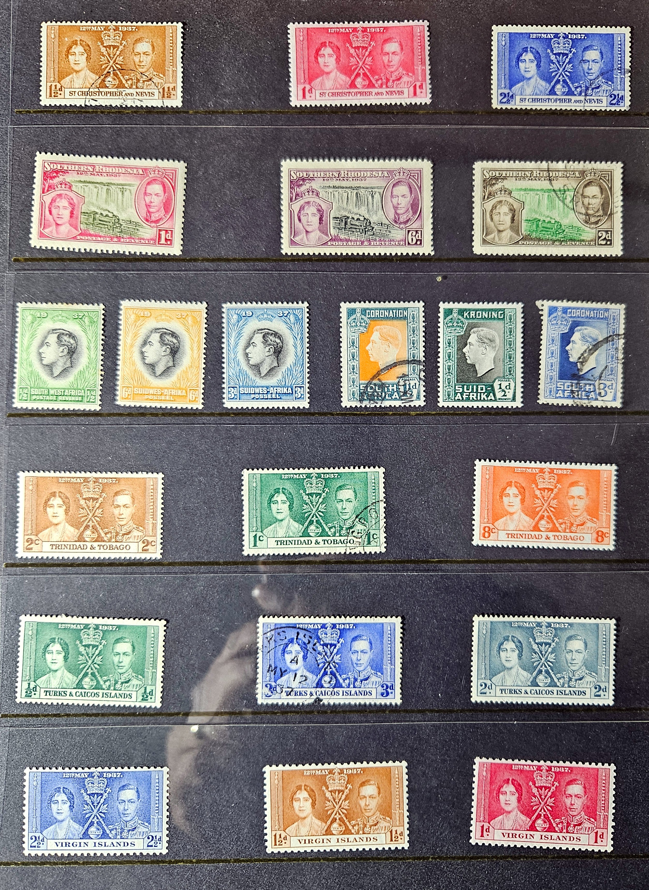 Collection of vintage stamps with royal portraits on a dark background