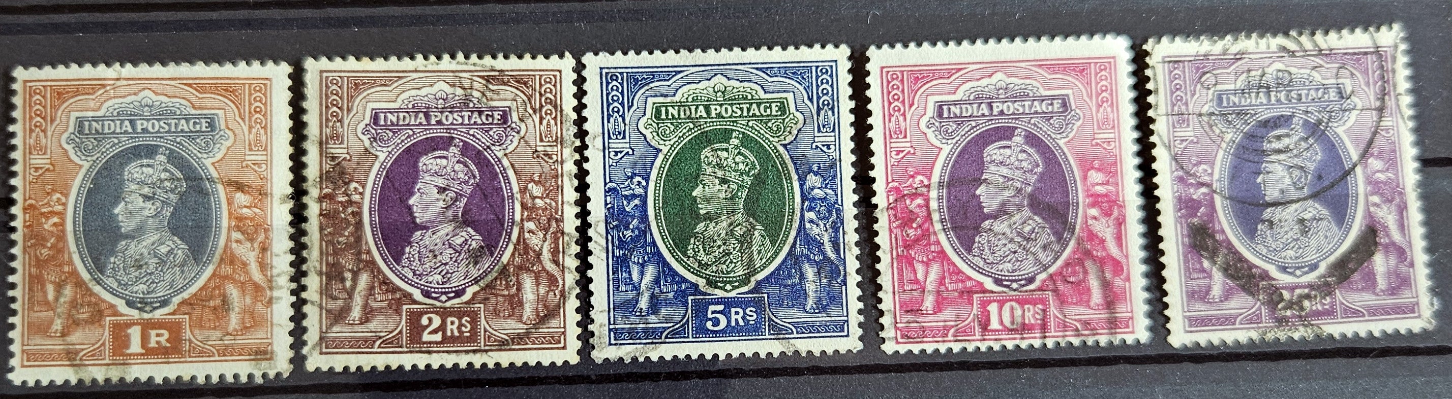 A selection of vintage India stamps from various regions and periods, displayed in a row.