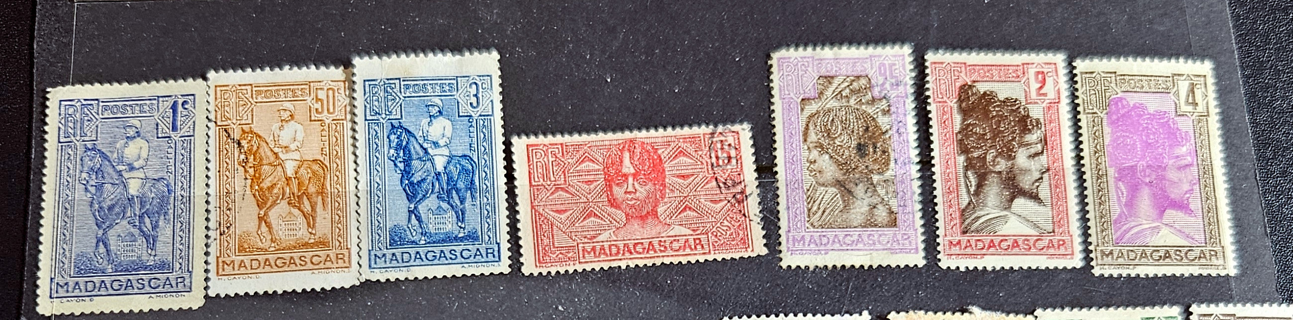 A set of vintage stamps from French Madagascar, featuring various designs including floral patterns and portraits.