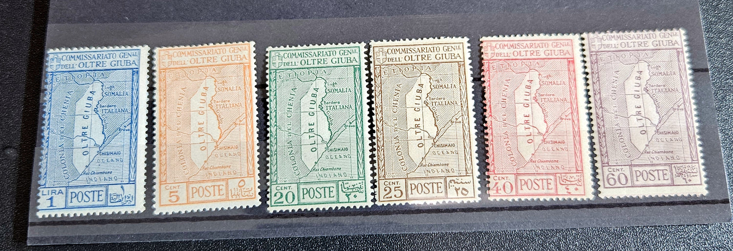 A set of vintage postage stamps from OLTRE GIUBA JUBALAND in various colors displayed on a flat surface.