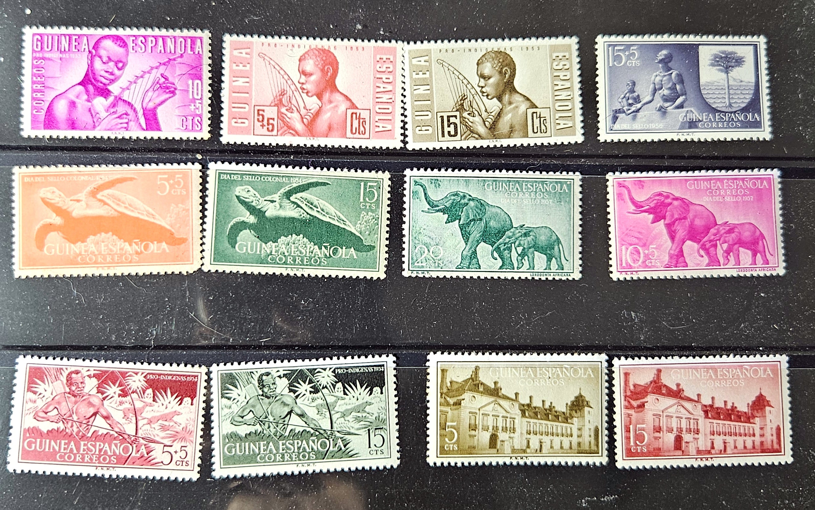 Collection of vintage stamps with various designs on a dark background