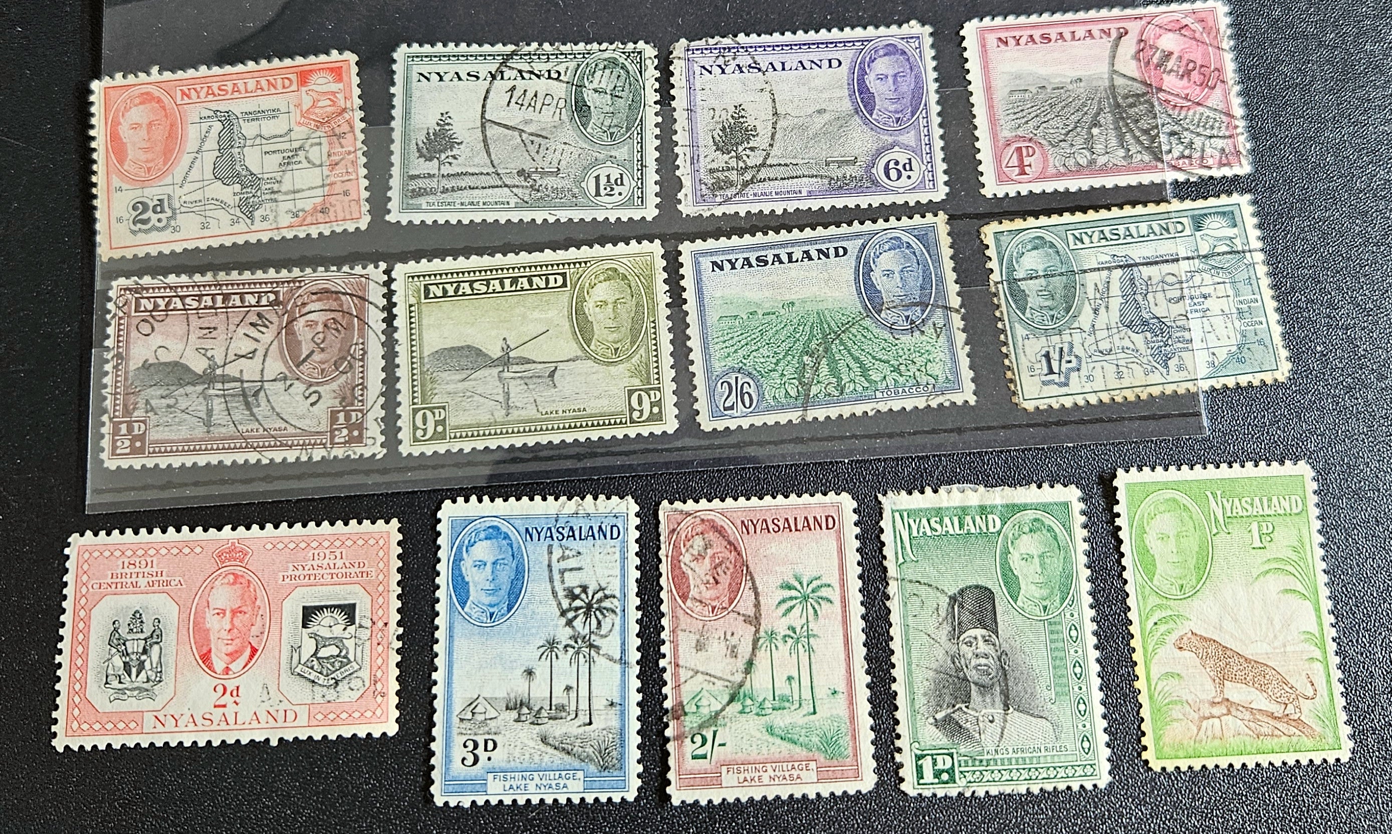 A collection of Nyasaland vintage stamps displaying various images and text, arranged in a row.