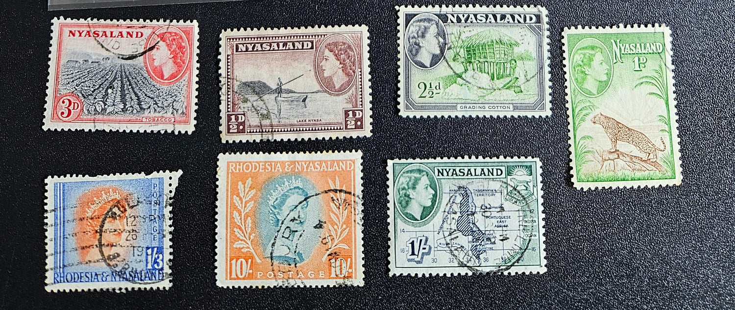 A collection of Nyasaland vintage stamps displaying various images and text, arranged in a row.