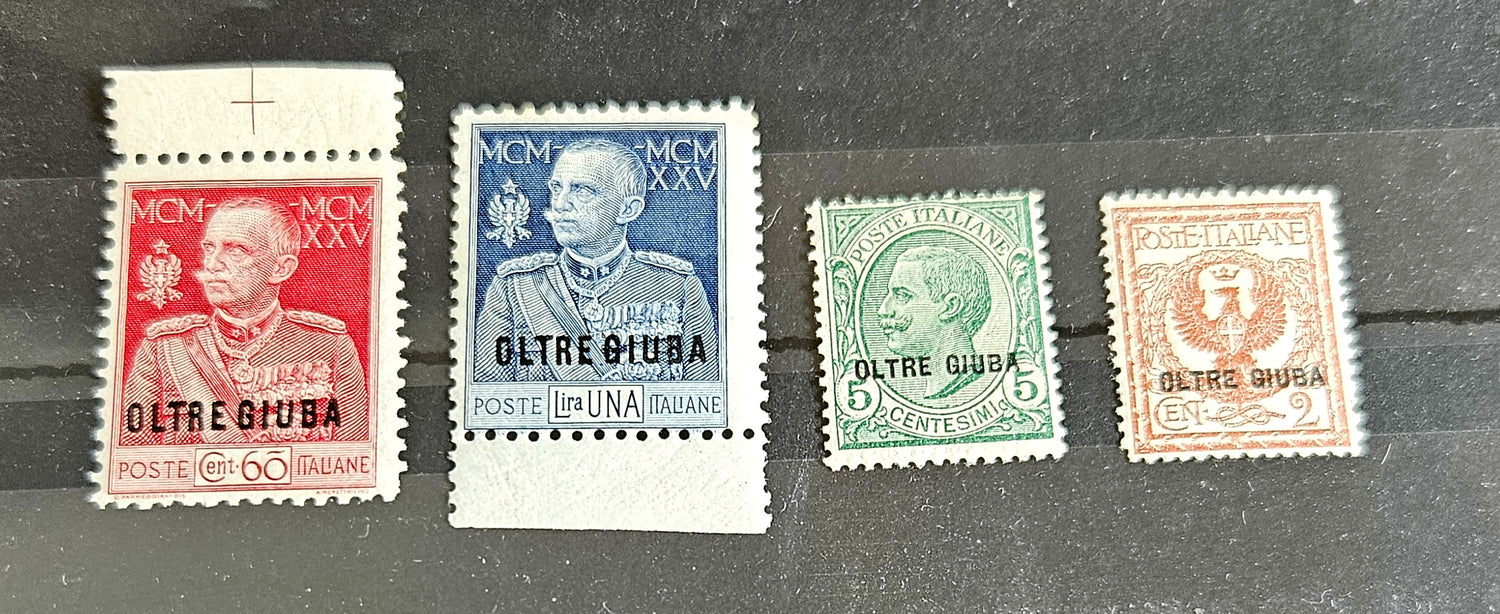 A set of vintage postage stamps from OLTRE GIUBA JUBALAND in various colors displayed on a flat surface.