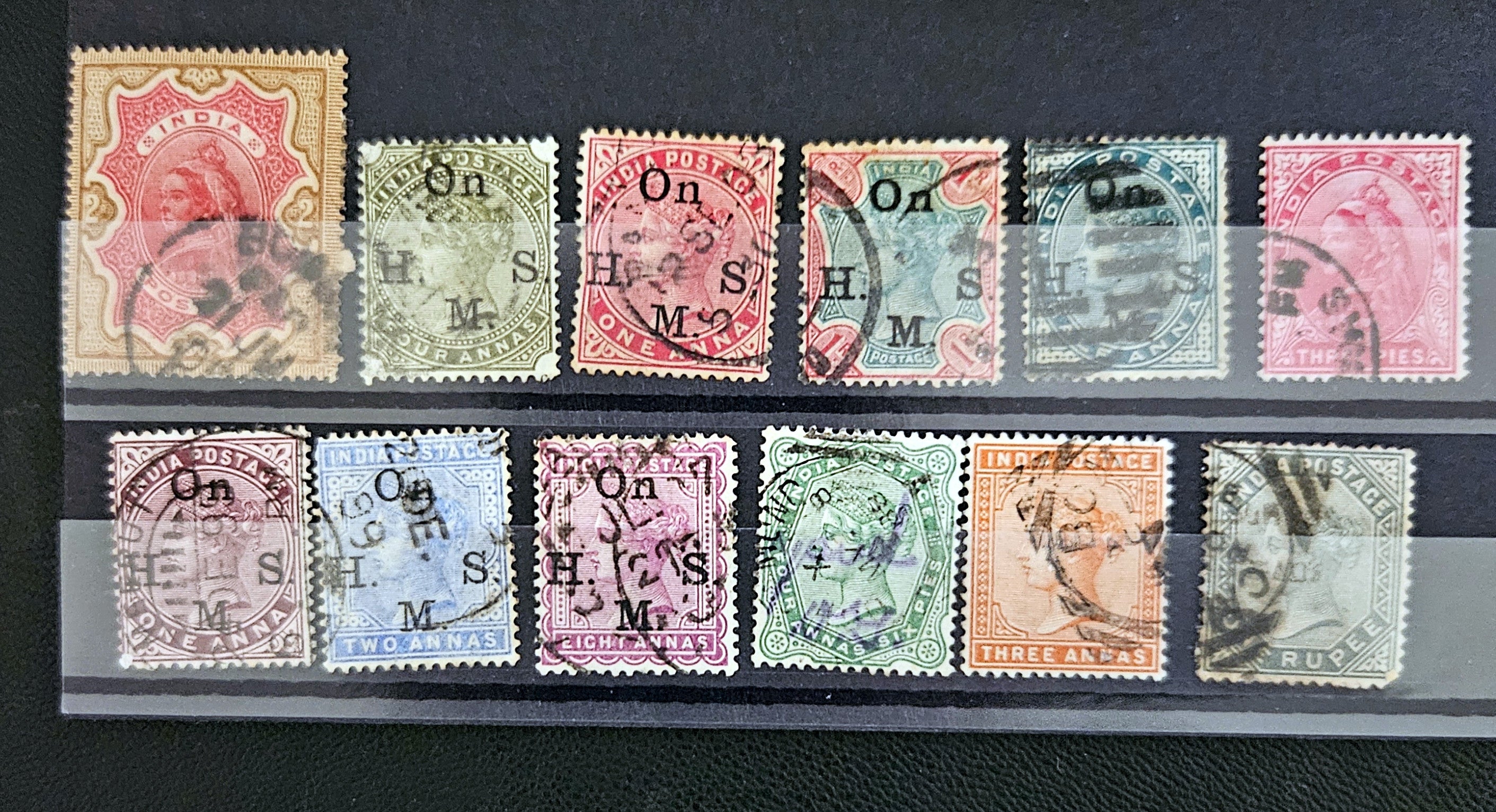 Collection of vintage stamps with different designs and colors on a black background